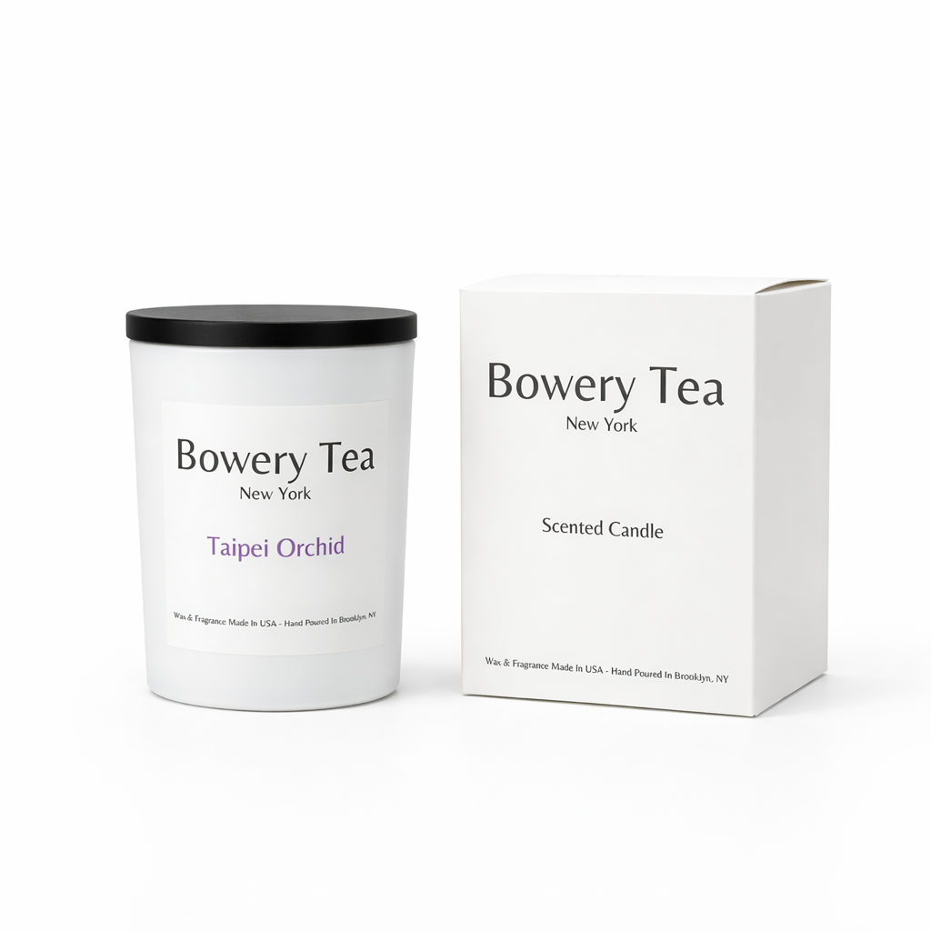 Bowery Tea Taipei Orchid scented candle in white glass container with black lid and packaging box