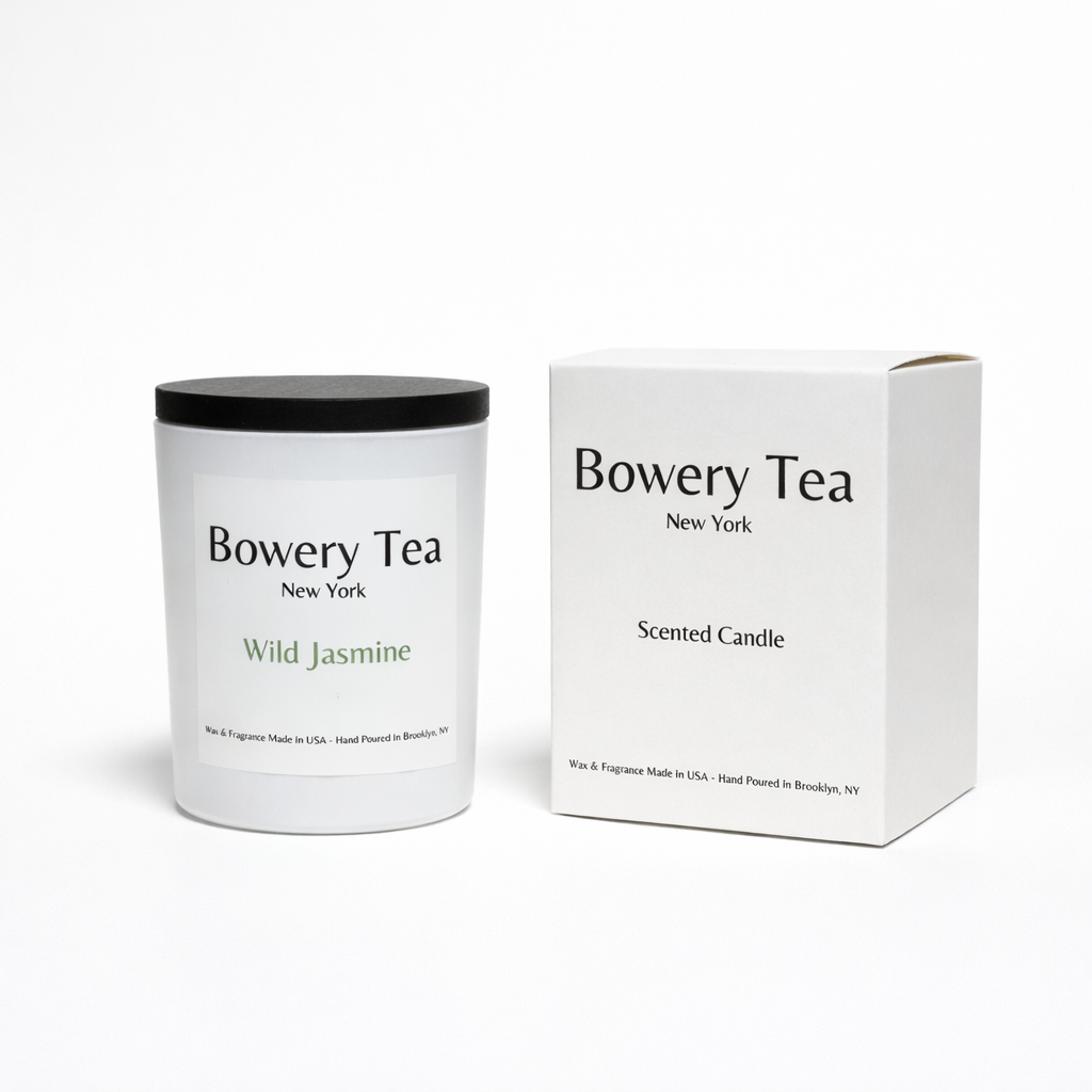 Bowery Tea Wild Jasmine scented candle in white glass container with black lid and packaging box