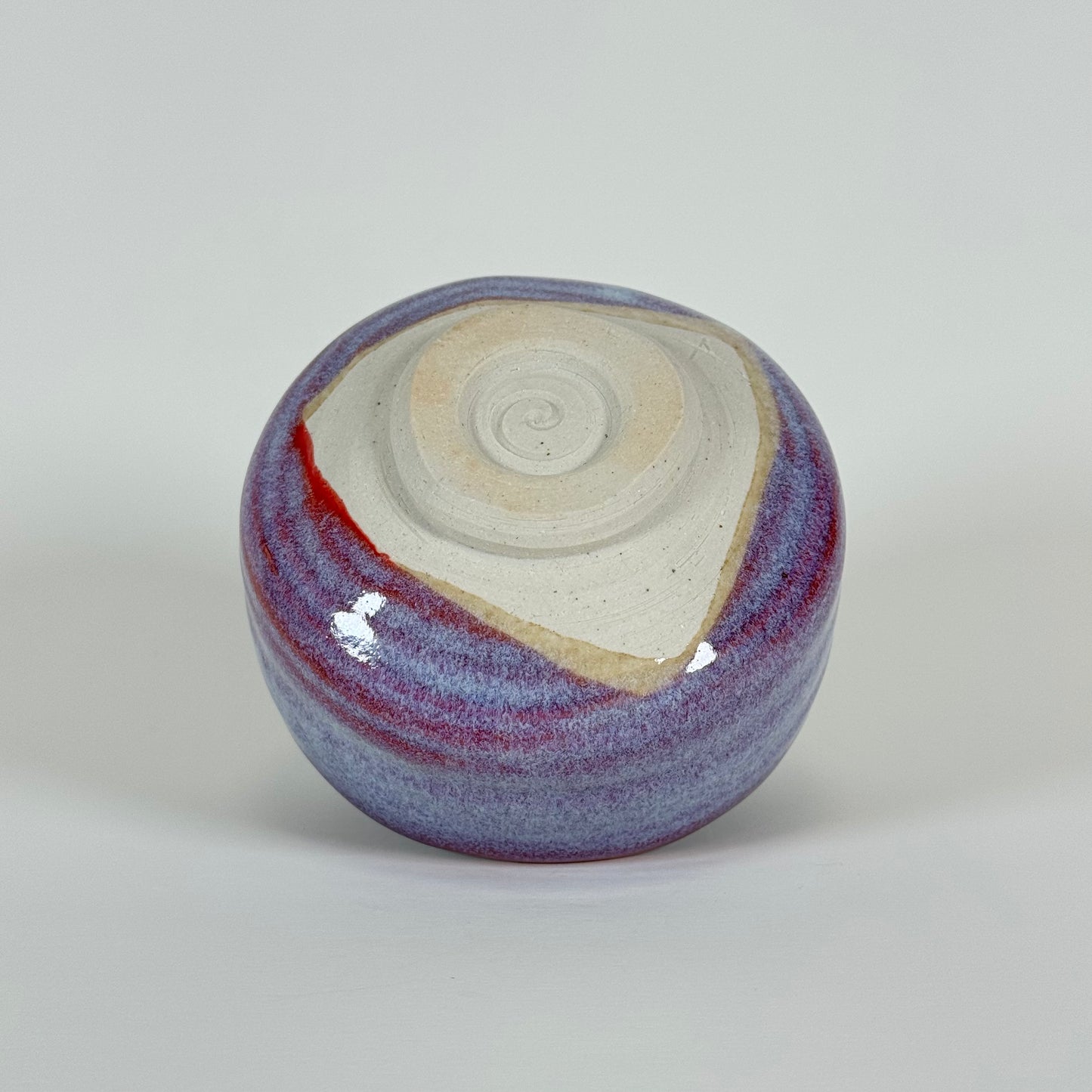 Base of handmade Crimson Dawn ceramic matcha bowl showing traditional chawan foot ring
