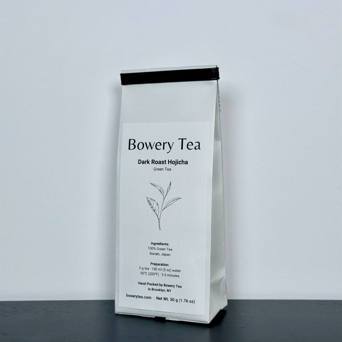 Bowery Tea Dark Roast Hojicha package on a gray background