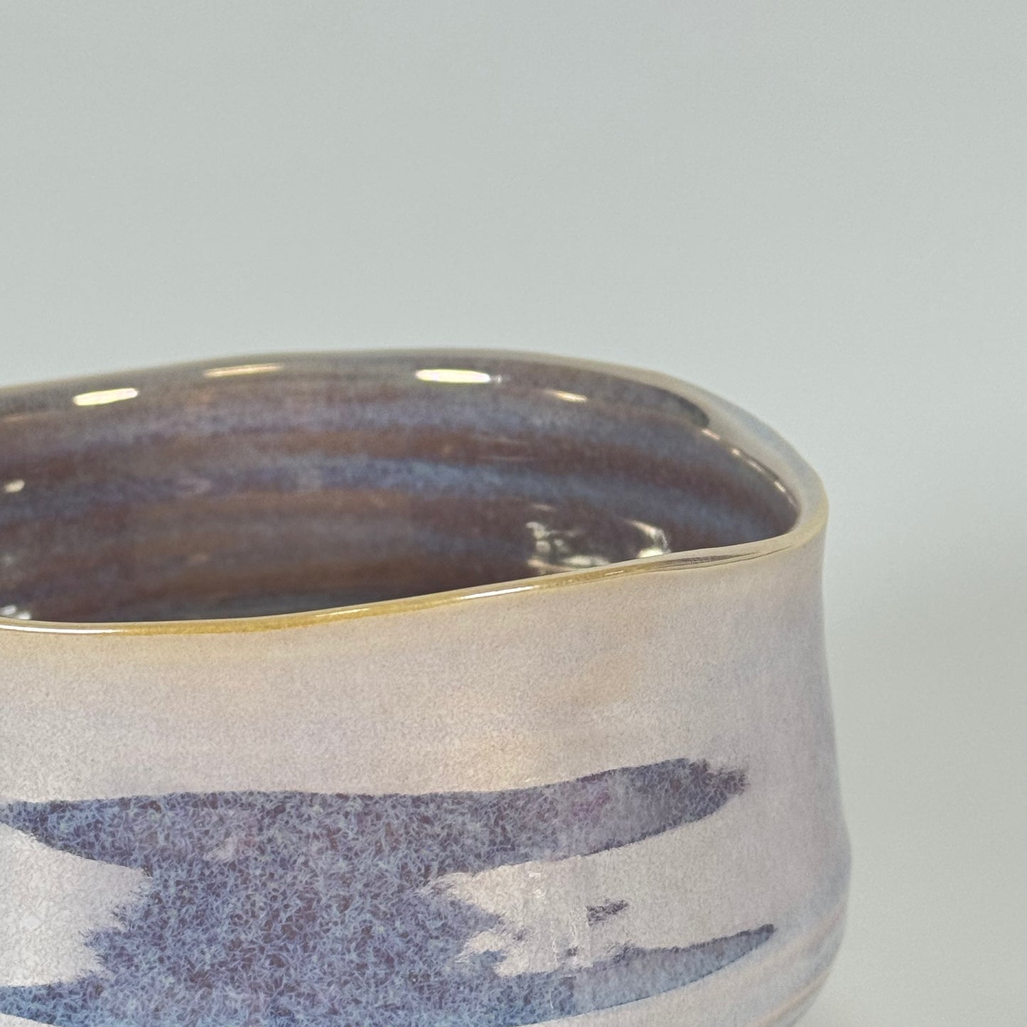 Detail of Pear Mist matcha bowl showing pearlescent glaze and lavender blue banded pattern