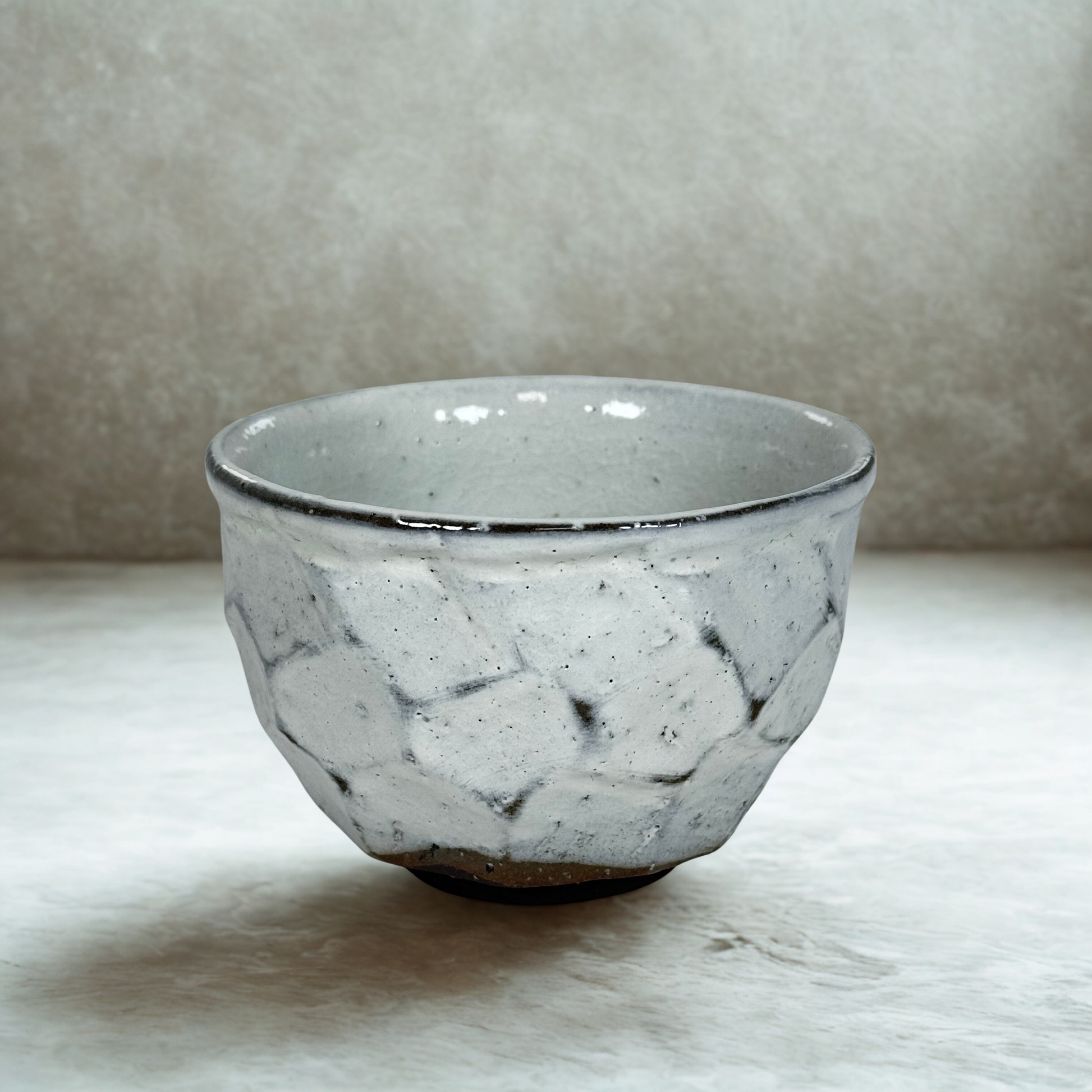 Handmade Japanese matcha bowl with white ash glaze and stone textured ceramic chawan