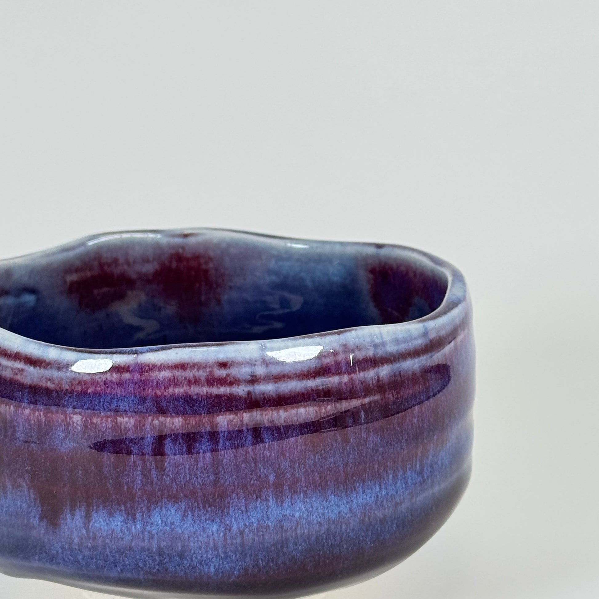 Handmade Japanese amethyst haze matcha bowl showing side profile and layered glaze