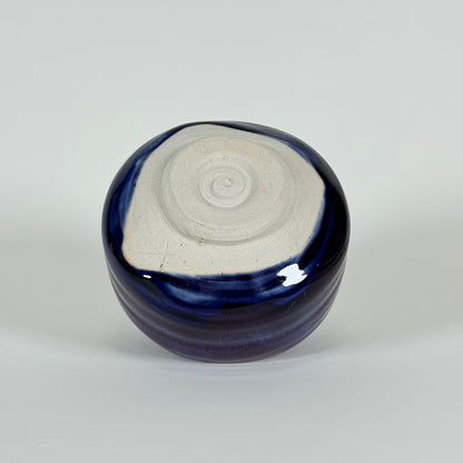 Bottom view of handmade Japanese amethyst haze matcha bowl showing unglazed foot