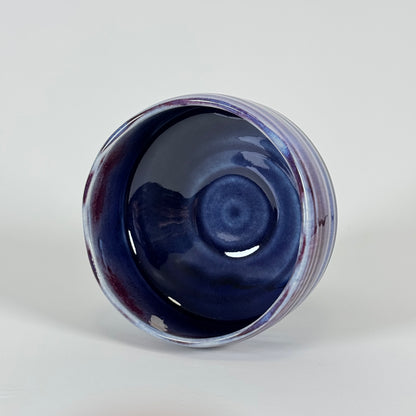 Interior view of handmade Japanese amethyst haze chawan with deep blue glaze