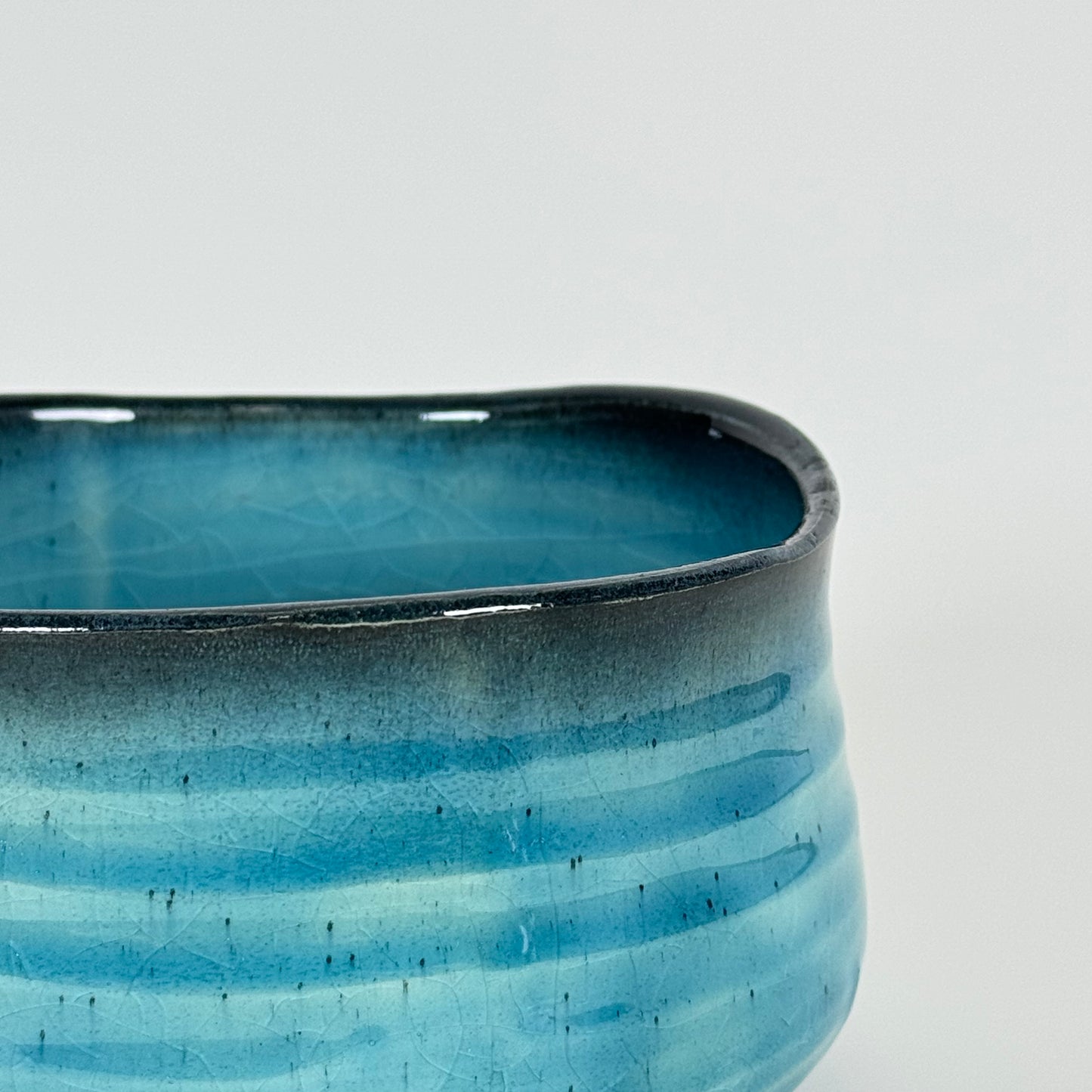 Detail of Azure Horizon matcha bowl showing blue gradient glaze and soft charcoal rim
