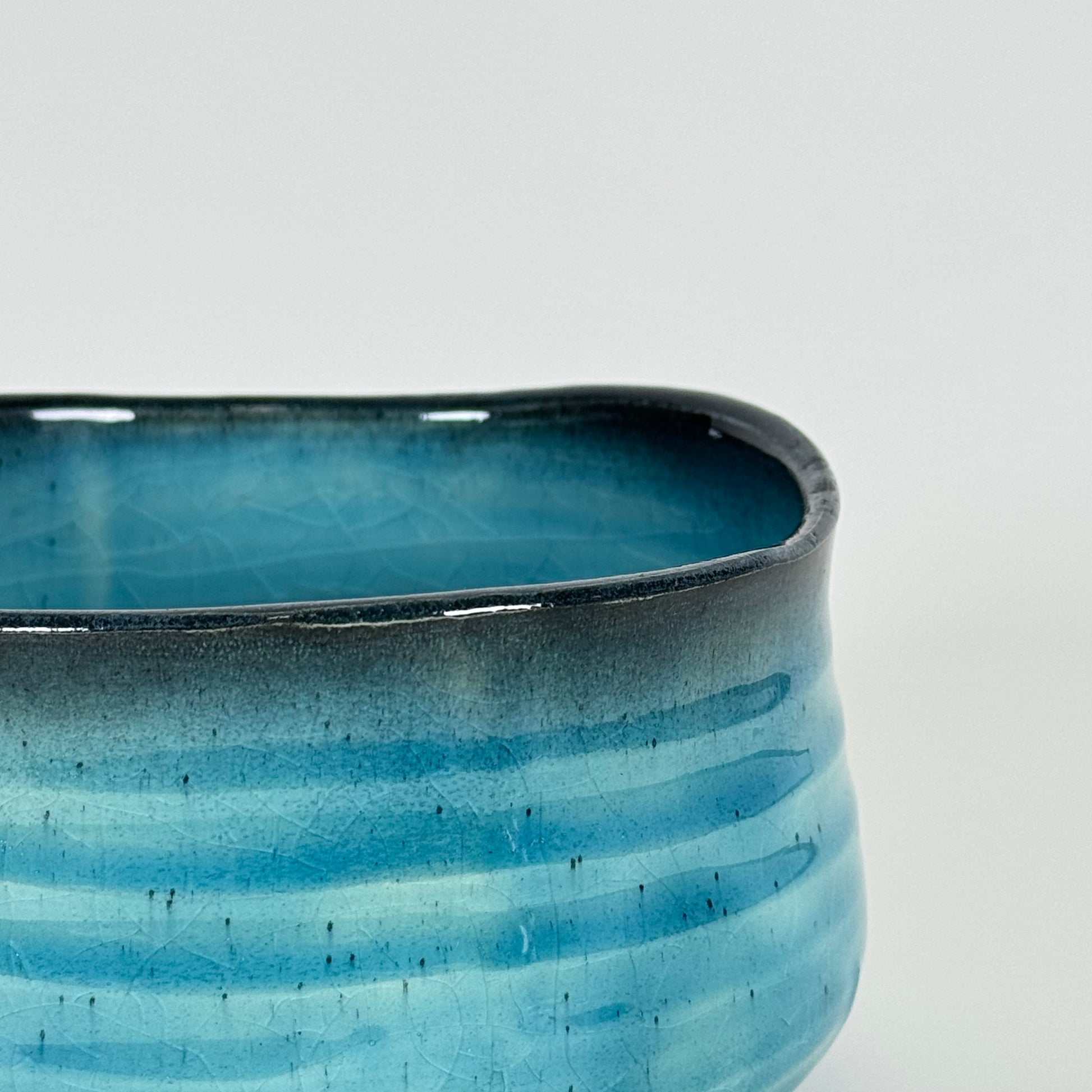 Detail of Azure Horizon matcha bowl showing blue gradient glaze and soft charcoal rim
