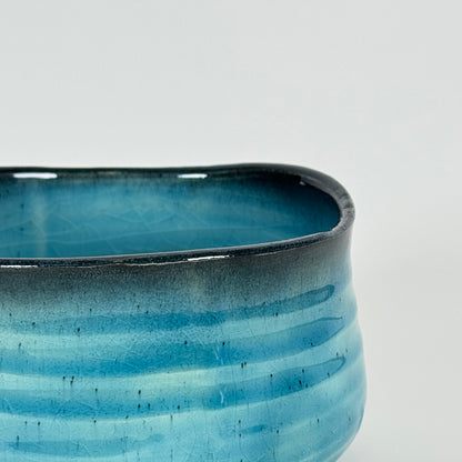Detail of Azure Horizon matcha bowl showing blue gradient glaze and soft charcoal rim