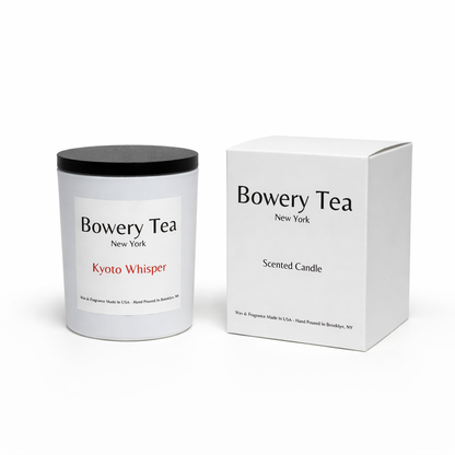 Bowery Tea Kyoty Whisper scented candle in white glass container with black lid and packaging box