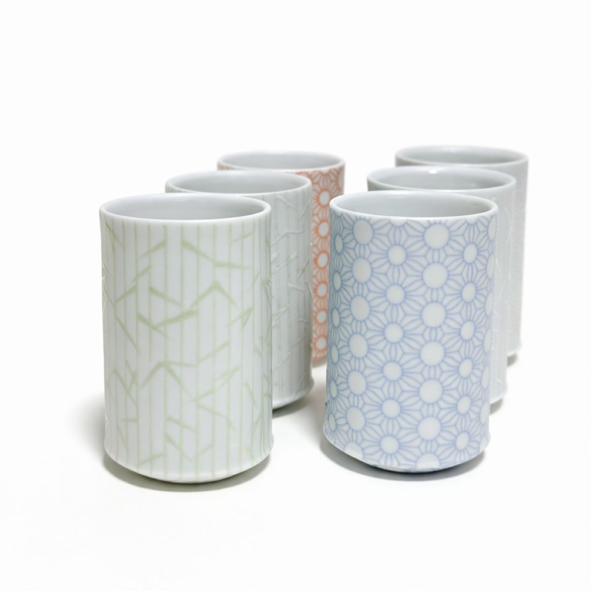 ceramic tea cups with geometric pattern on white background