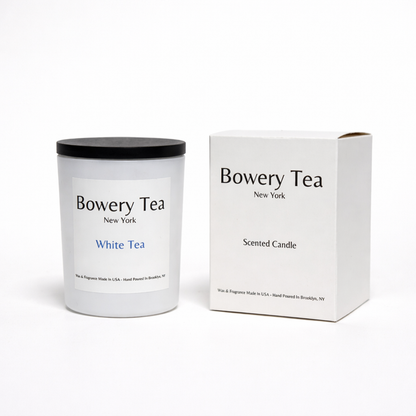 Bowery Tea White Tea scented candle in white glass container with black lid and packaging box
