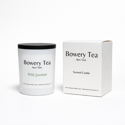 Bowery Tea Wild Jasmine scented candle in white glass container with black lid and packaging box