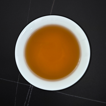 amber liquor of charcoal roasted oolong tea in white cup