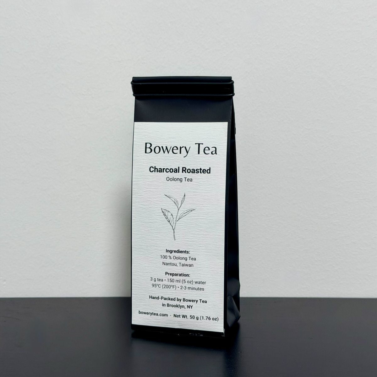 Bowery Tea charcoal roasted oolong tea package on a gray background