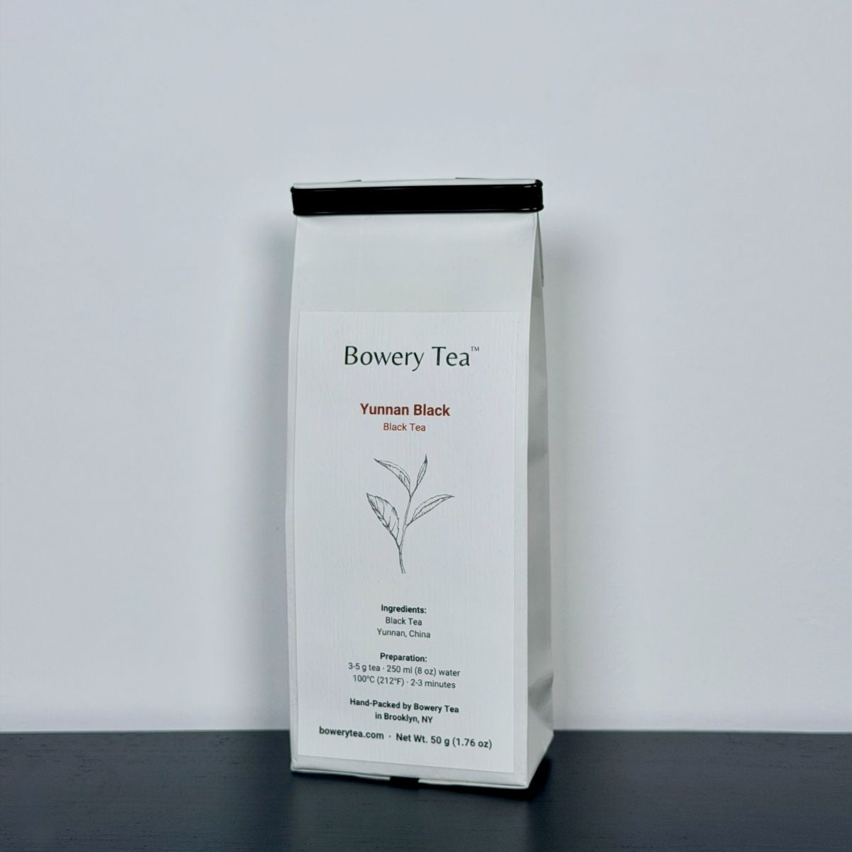 Bowery Tea Yunnan Black tea package on a gray background
