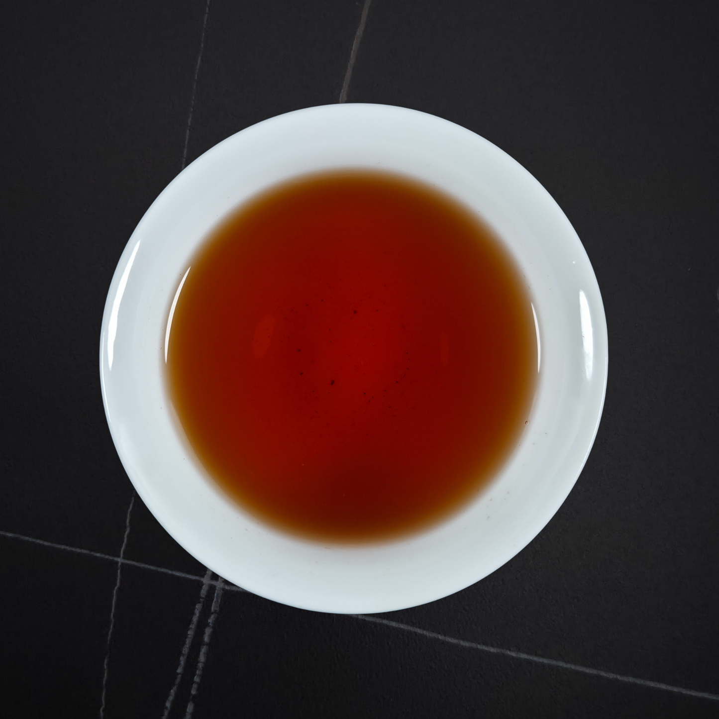 Brewed China Zheng Shan black tea with deep amber liquor