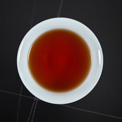 Brewed China Zheng Shan black tea with deep amber liquor