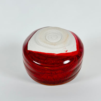 Handmade Japanese crimson glazed matcha bowl showing unglazed foot and base detail
