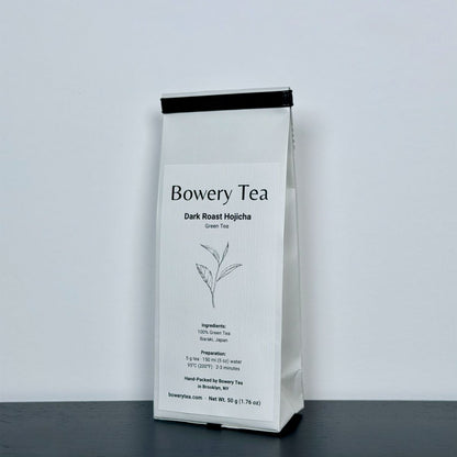 Bowery Tea Dark Roast Hojicha package on a gray background