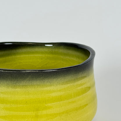 Detail of Golden Dawn matcha bowl showing yellow glaze fading into dark charcoal rim