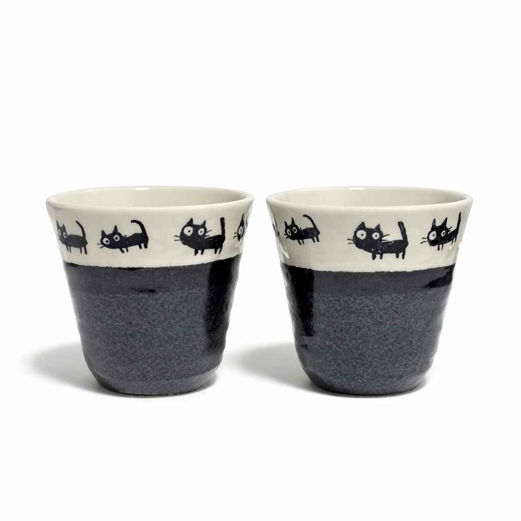 Set of two porcelain teacups with black cat illustrations ivory interior and charcoal glaze