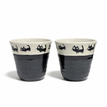 Set of two porcelain teacups with black cat illustrations ivory interior and charcoal glaze