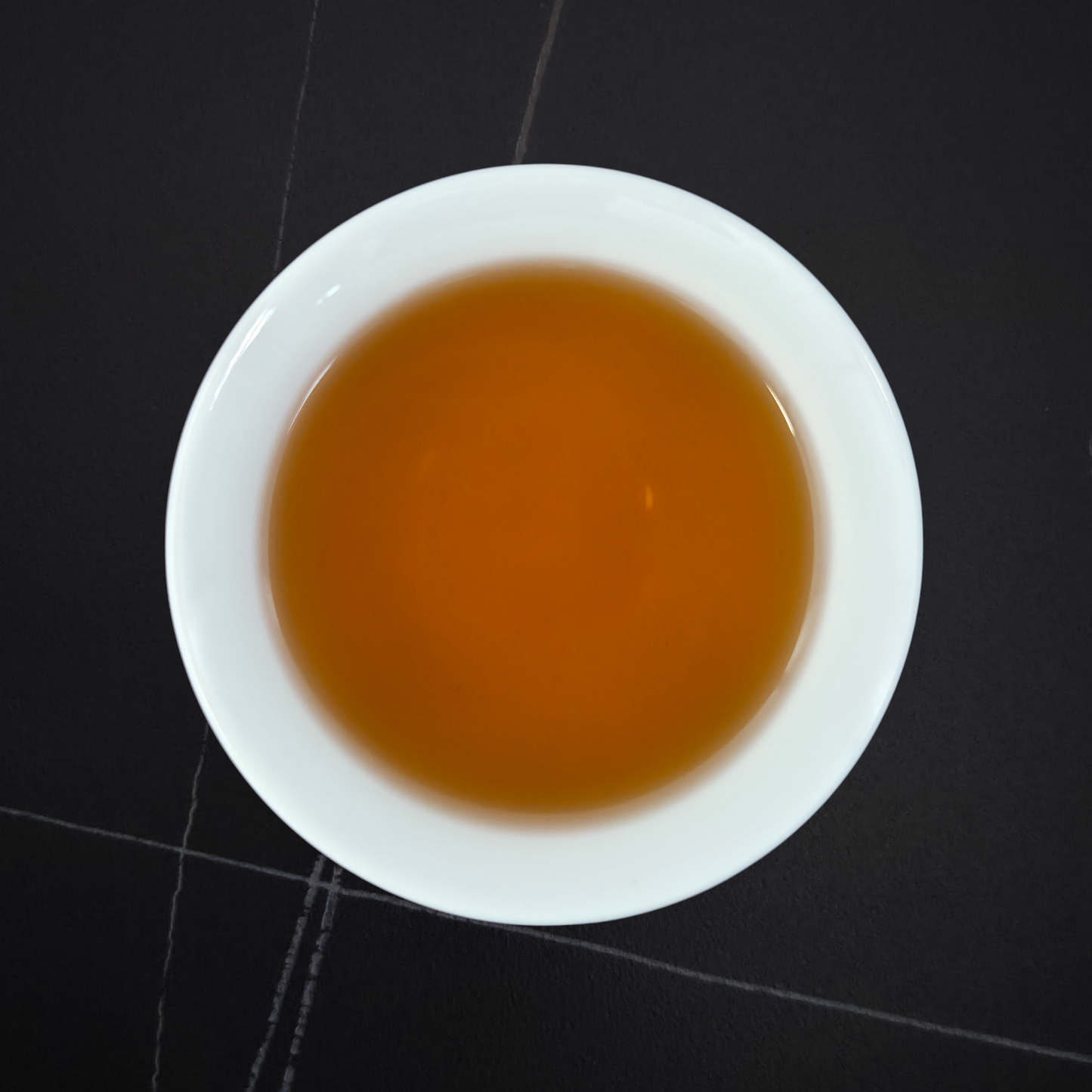 golden infusion of light roast hojicha in white cup