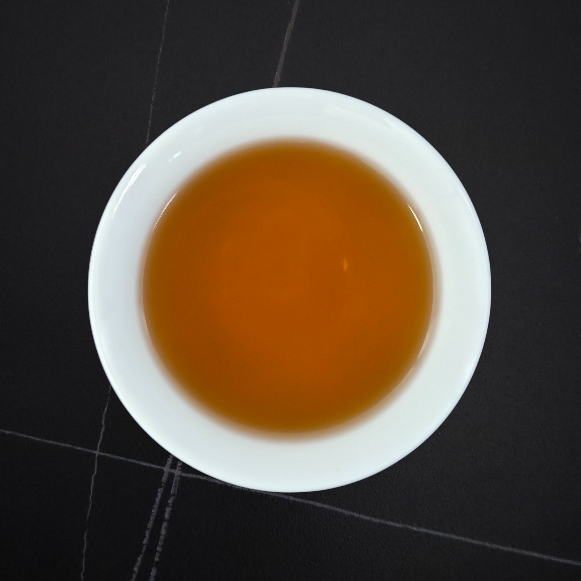 golden infusion of light roast hojicha in white cup