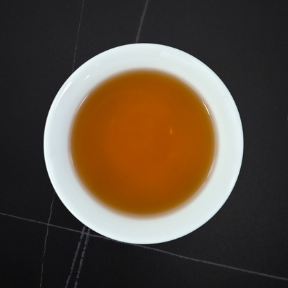 golden infusion of light roast hojicha in white cup