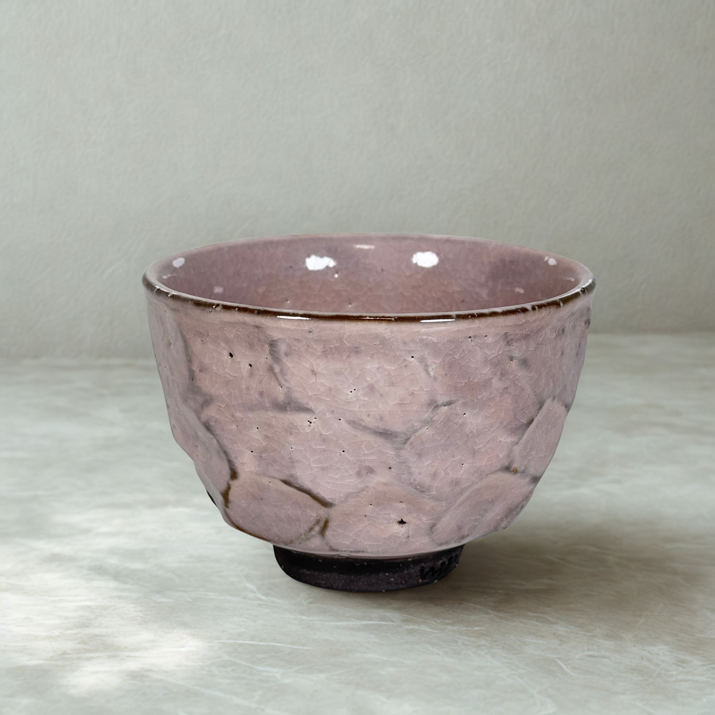 Handmade Japanese matcha bowl with cracked pink sakura glaze textured ceramic chawan