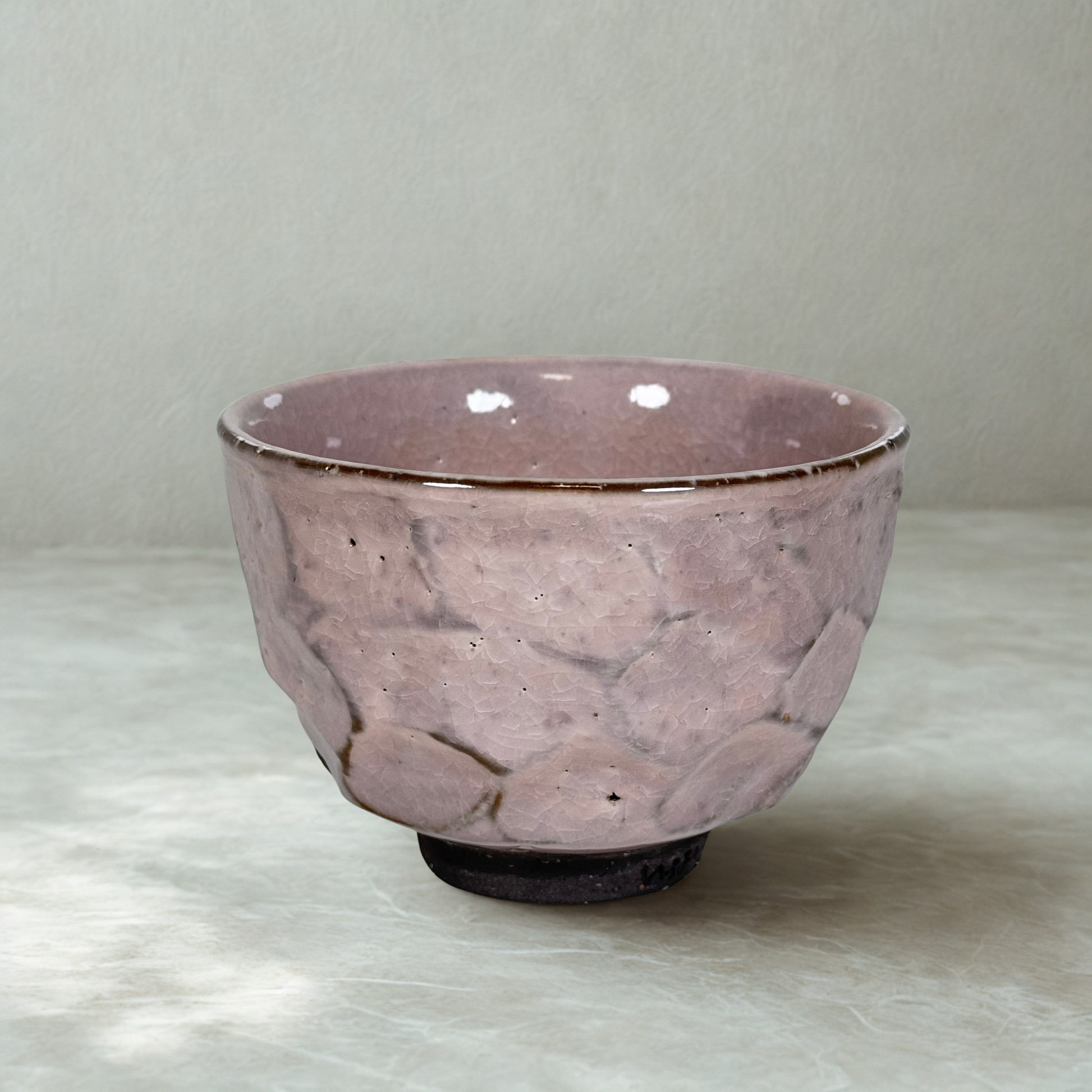 Handmade Japanese matcha bowl with cracked pink sakura glaze textured ceramic chawan