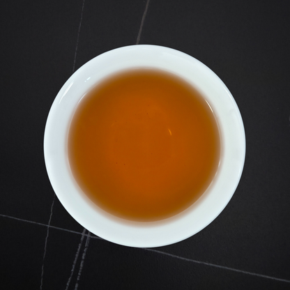 amber liquor of taiwan red oolong tea in white cup