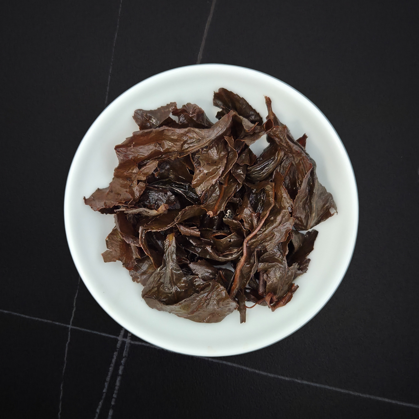 wet leaves of red oolong showing twisted brown leaves