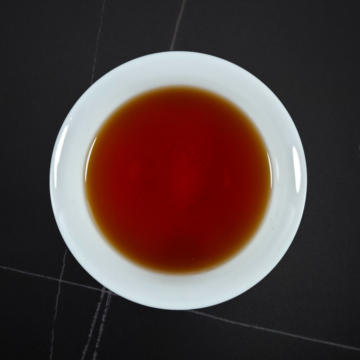 Brewed Taiwan Sun Moon Lake black tea with deep amber liquor